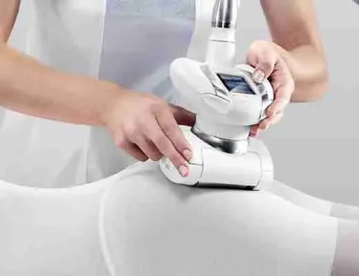 Technicienne utilise un appareil esthétique sur la cuisse d’une cliente.